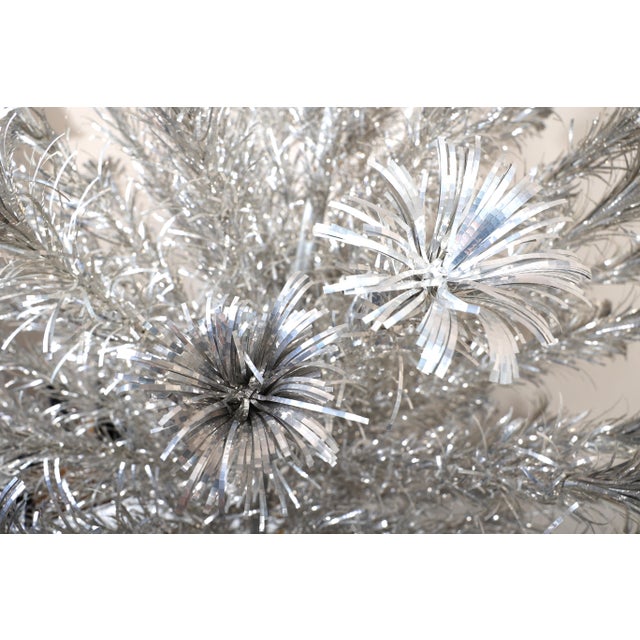 Spectacular 6 foot aluminum Christmas tree by Silverline. Complete tree in the original box. Tree is bright and shiny and...