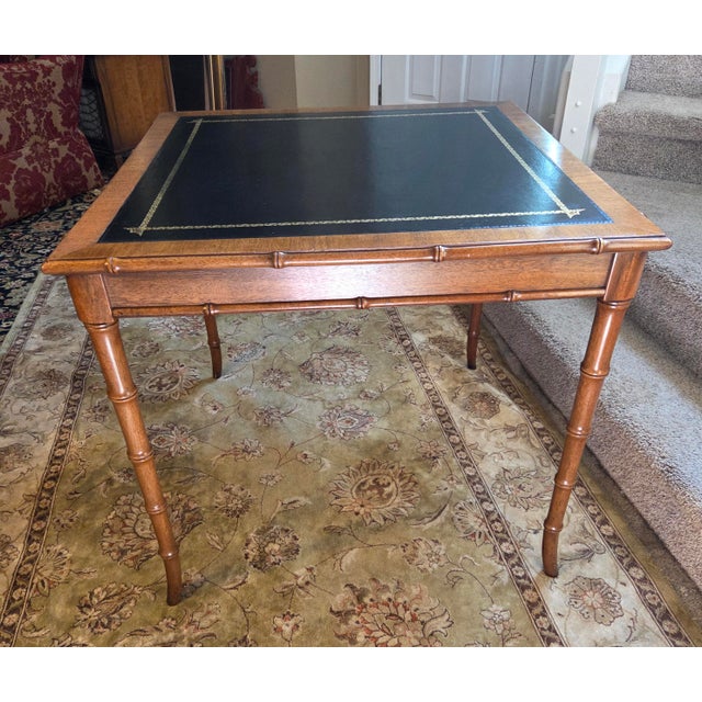 Gorgeous, vintage Hollywood Regency card/game table featuring a stunning faux bamboo wood frame and a premium inset gold...