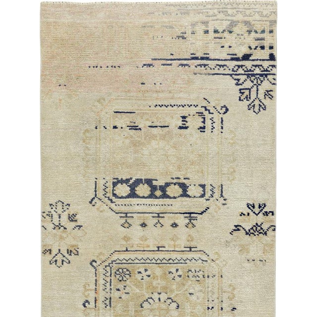 This mid-20th-century Turkish Anatolian runner presents a vertical sequence of softly drawn octagonal medallions across a...