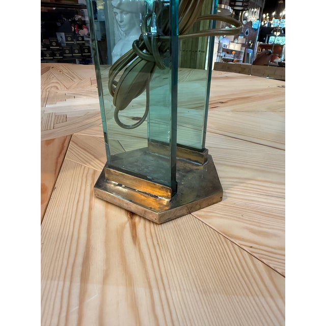 Elegant pair of modernist table lamps attributed to Fontana Arte, featuring sculptural brass frames combined with striking...