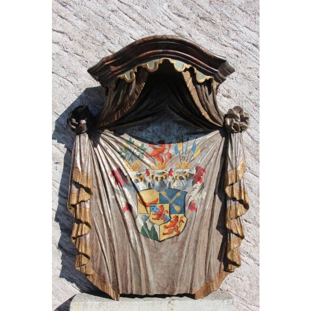 Large heraldic mantle panel in carved and painted wood with a gold and silver leaf finish, generally in good condition;...