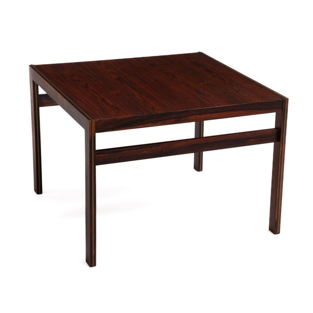 A versatile Mid-Century Danish table by CFC Silkeborg. Rosewood with brass inlay. This stunning square table will serve...
