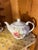 1950s, Mid 20th Century porcelain tea pot with hand-painted floral motifs and gold gilded accents. A wind-up music box...