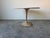 A classic and sculptural vintage dining table featuring an elegant tulip-style metal base paired with a beautiful round...