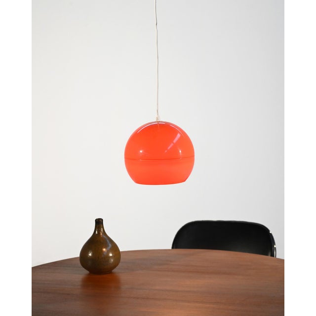 Glossy orange plastic spherical diffuser with a Space Age design. Scandinavian production from the 1960s. This ceiling...