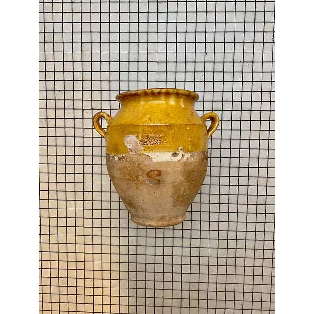 Beautiful 19th-century French terracotta confit pot with its characteristic warm mustard glaze and classic double handles....