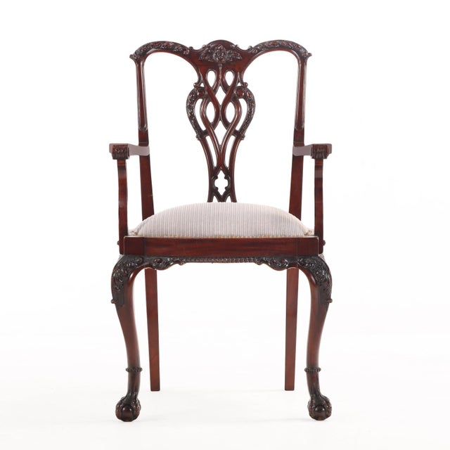 An exceptional and rare set of 12 English Chippendale style armchairs, finely crafted in richly figured mahogany. Each...