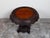 A Burmese hand-carved side table from the 19th century, with mythical animals and foliage. Created in Burma during the...