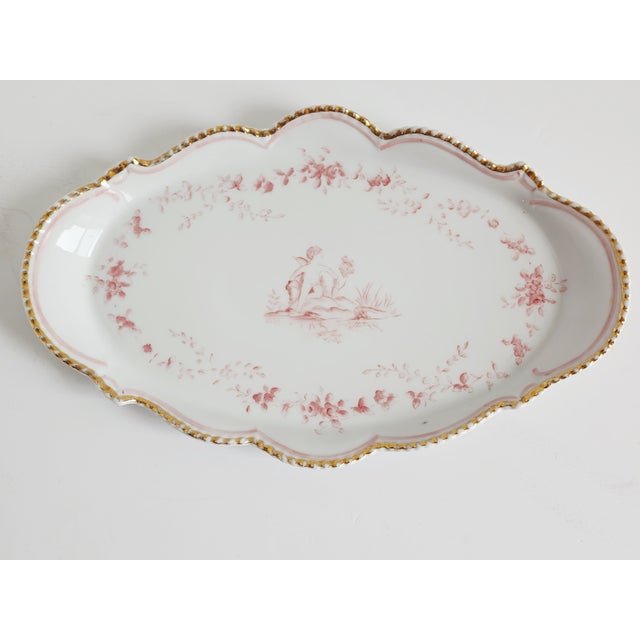 Vintage 1950's small scalloped porcelain platter with hand painted cherubs in a light pink and gold trims. The platter is...