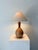 A sleek turned wood table lamp from the Mid Century. The curvature of the base is echoed and emphasised by skilled inlay...