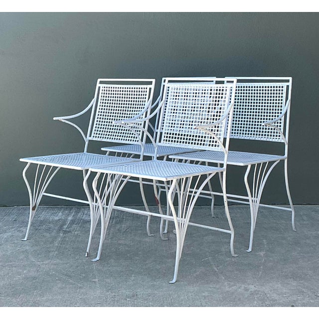 This quintessentially Mid-Century Modern outdoor dining set exudes timeless garden charm and architectural elegance....