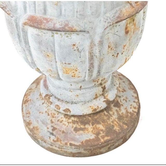 A magnificent pair of cast iron architectural finials in the form of a pineapple or pinecone-a classical motif symbolizing...