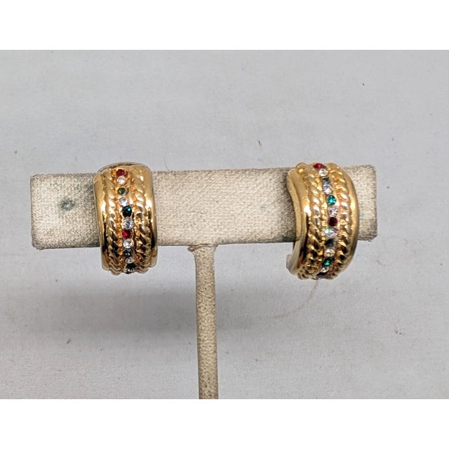 1970s goldtone half hoops with a line of round faux-rubies, sapphires & emeralds with clear round rhinestones in between...
