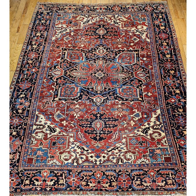 "This exceptional late 19th-century Persian Heriz Serapi rug from Northwest Persia. The rug features a deep, dark red...