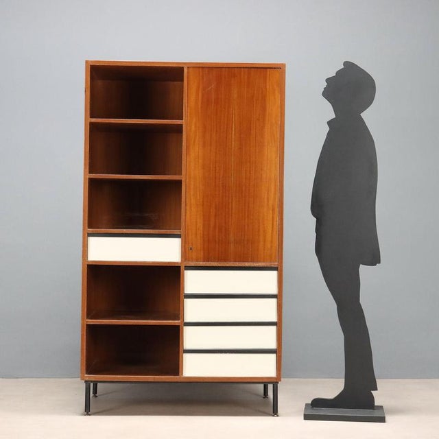 Vintage Italian-made piece of furniture made of wood with mahogany veneer, featuring open compartments, a hinged door, and...