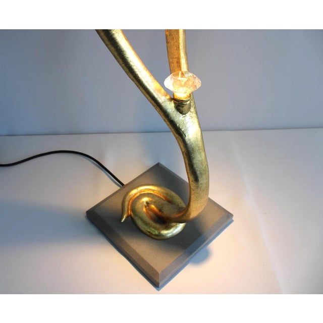 This table lamp from the cobra series impresses with its italian modern elegance. the lamp base as a stylized cobra is...