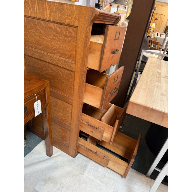 Design Plus Gallery presents a Quarter-Sawn Oak Wood Filing Cabinet. The tall case displays prominent oak grain, paneled...
