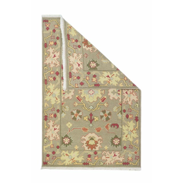 A single, broad border of jagged palmettes, frames a same tone field with a central elaborated lobed straw rosette,...