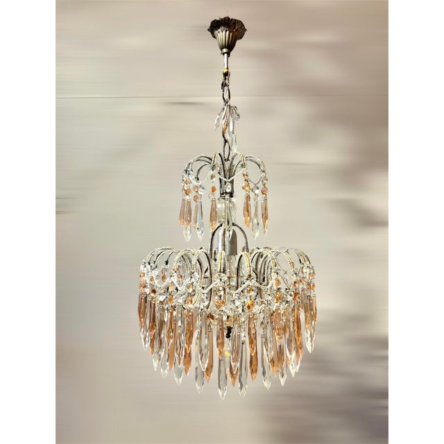 This refined Italian chandelier from the 1950s is crafted in a finely detailed waterfall-style beaded structure and...