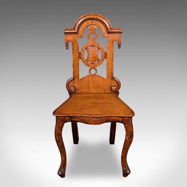 This is an antique reception hall chair. A Scottish, golden oak side or occasional seat, dating to the early Victorian...