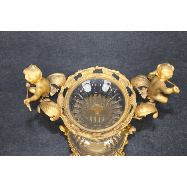 An exceptionally decorative French Belle Époque gilt-bronze and glass urn or vase, conceived in the exuberant Rococo...