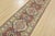 A tribal Caucasian Kazak runner hand-knotted with fine wool on a cotton foundation. This rug features a row of geometric...
