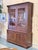 French walnut hutch cabinet crafted with a classic two piece design consisting of an upper glazed display cabinet and a...