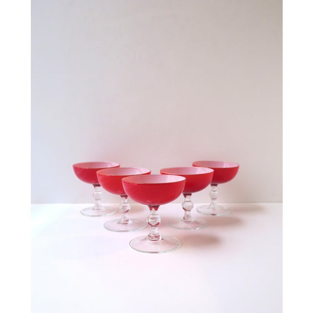 A chic set of five (5) vintage red and white Italian Murano Champagne coupes or cocktail glasses, by designer Carlo...