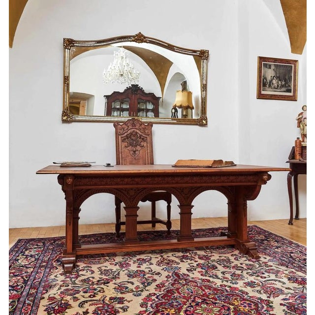 This impressive writing or dining table is made of solid oak and is a top example of neo-Gothic furniture from the second...