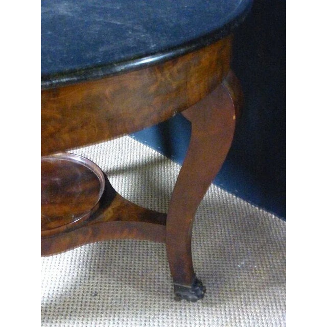 Beautiful mahogany pedestal table with its marble basin. The feet, finished with bronze shoes, are joined by a central...