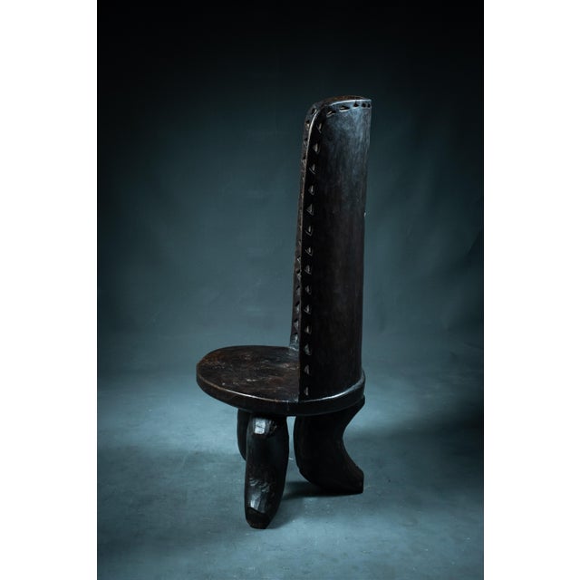 A rare and sculptural piece, this royal throne from Tanzania embodies the essence of tribal design. Cut from a single...
