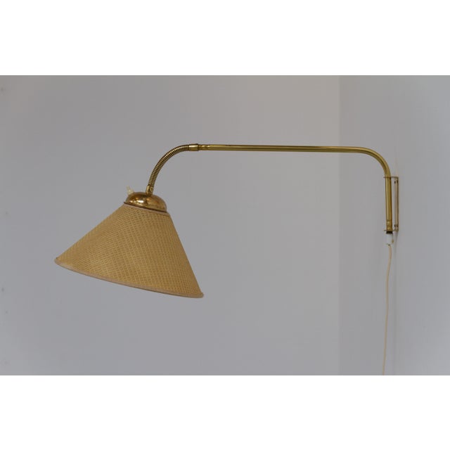 Swedish swivel arm brass wall lamp by eae, 1950s. scandinavian mid-century modern adjustable brass wall light designed and...