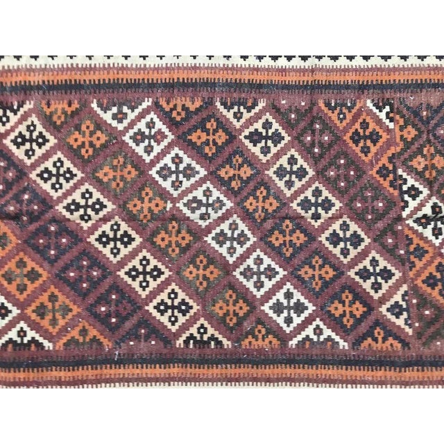 Nice mid-20th century Kilim with a geometric tribal design and beautiful colors with orange, purple, black and green,...