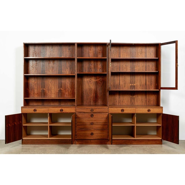 This impressive vintage Swedish mid-century modern three-section bookcase cabinet system was designed by Bertil Fridhagen...