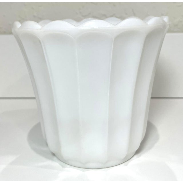 Vintage milk glass flower pot vase with scalloped rim. The scalloped rim is a classic mid-century design element, often...