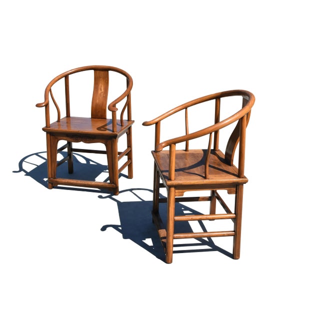 A pair of extra large, sold wood, 19th century Chinese Horseshoe Chairs. The solid, 2" thick, continuous rounded crest...
