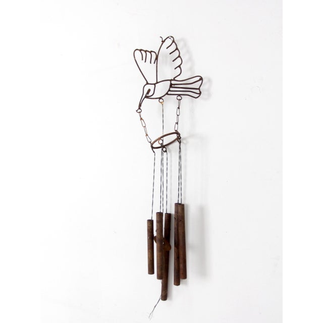 This vintage folk art wind chime features a hand-formed wire bird suspended above weathered metal chimes with a...