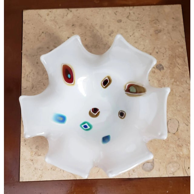 Bright white Murano art glass bowl/catchall featuring a rainbow of millefiore and a unique clipped edge design.