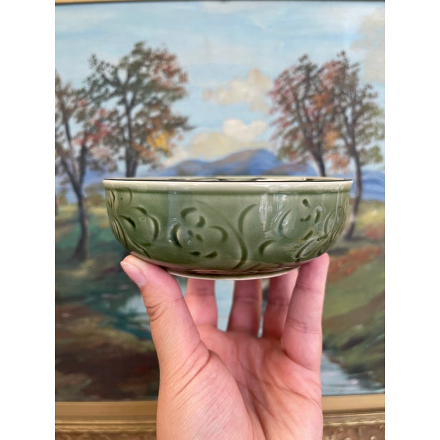 Vintage handcrafted ceramic bowl from the renowned Bat Trang pottery village in Vietnam. The exterior features an embossed...