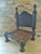 An antique Asian rustic low chair from the 19th century, probably from Burma. Carved backrest with hand woven seat, which...