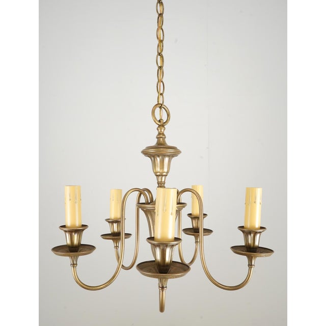 Colonial style brass chandelier with five swooping arms and patina finish. This light requires five standard Edison style...