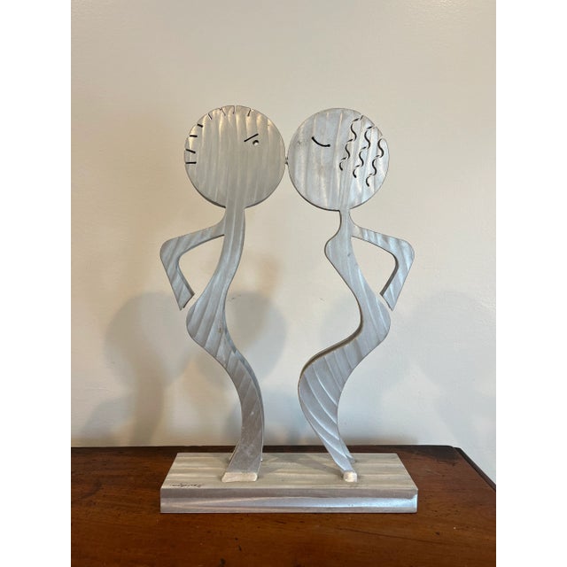 Rare postmodern figural sculpture of a kissing couple. Brushed aluminum signed and dated. Great whimsical postmodern...