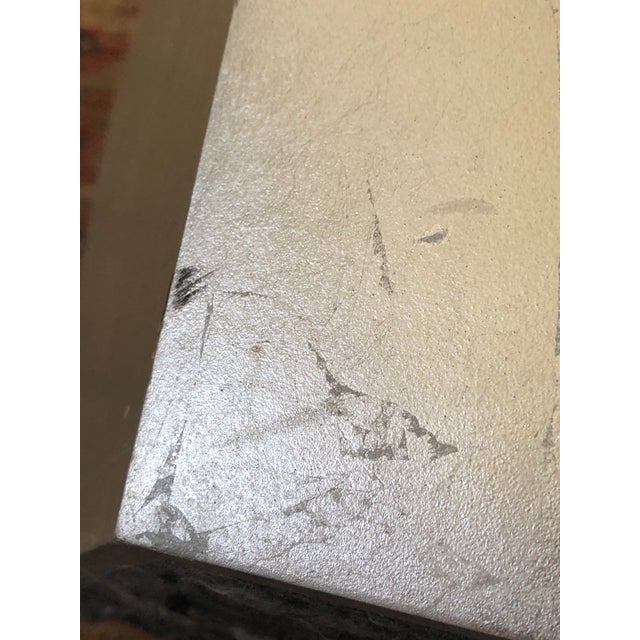 Small spot table designed by Barbara Barry, finished in silver leaf. This piece appears if it was chiseled from stone....