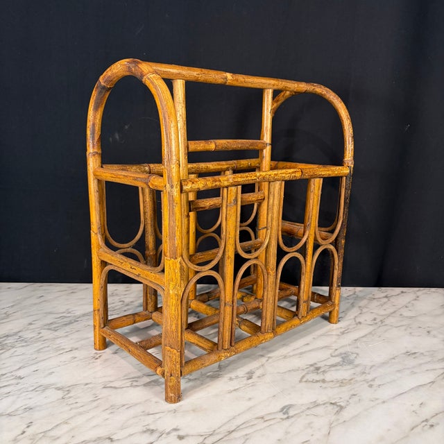 Antique burnt bamboo magazine with gracefully bent canes, arched handles, geometric bentwood detailing and a rich natural...