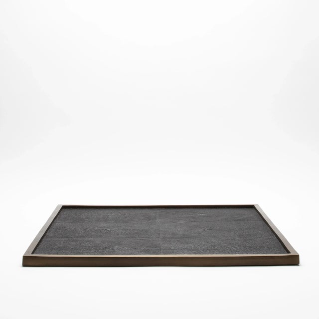 This large square tray by Kifu Paris features a luxurious black shagreen surface framed in bronze patina brass, creating a...