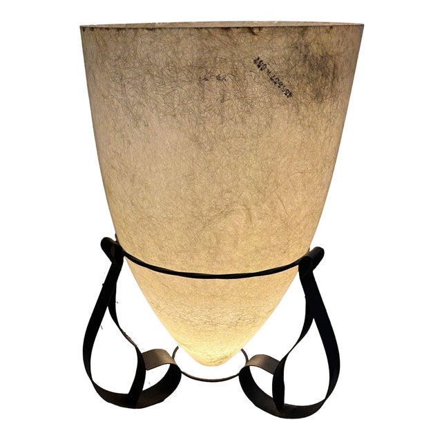 This mid-century modern lamp exudes a timeless charm, featuring a graceful fiberglass cone shade and a sturdy iron base....