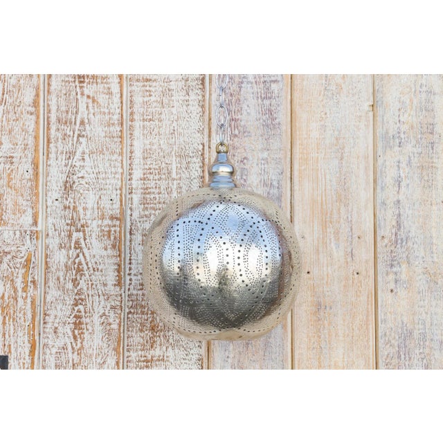 A delicately perforated Moorish pendant lantern. This pendant features pierced foliate see-through work which is all done...