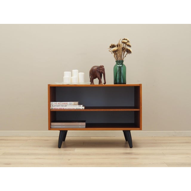 The bookcase was made in the 1970s, Danish production. The structure is covered with teak veneer. Legs made of solid wood...