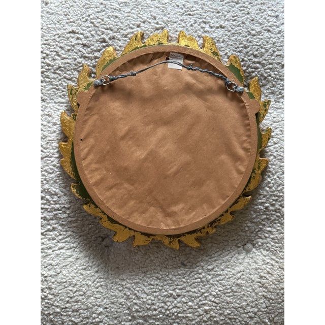 A beautifully detailed gilt laurel wreath mirror by Chelsea House, featuring sculptural leaves and berry accents in a rich...