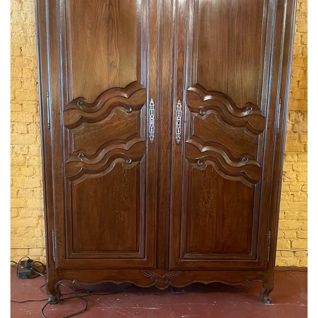a fine wardrobe from the beginning of the 19th century in oak-France Very nice work in relief on the paneled doors and...
